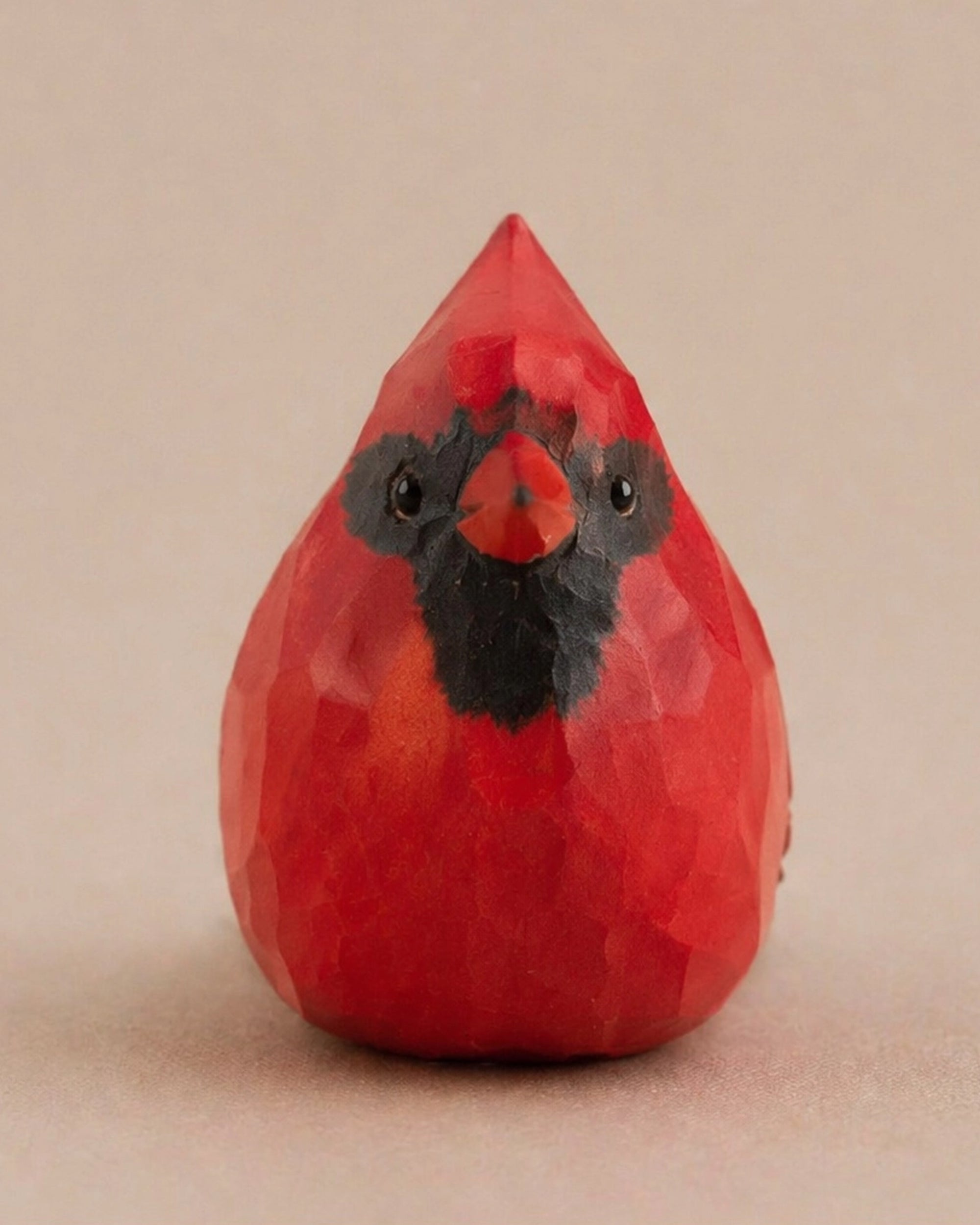 Red hand-painted carved wood bird with black accents, cardinal-inspired decor by Faire for Bungalow Furniture &amp; Accessories.