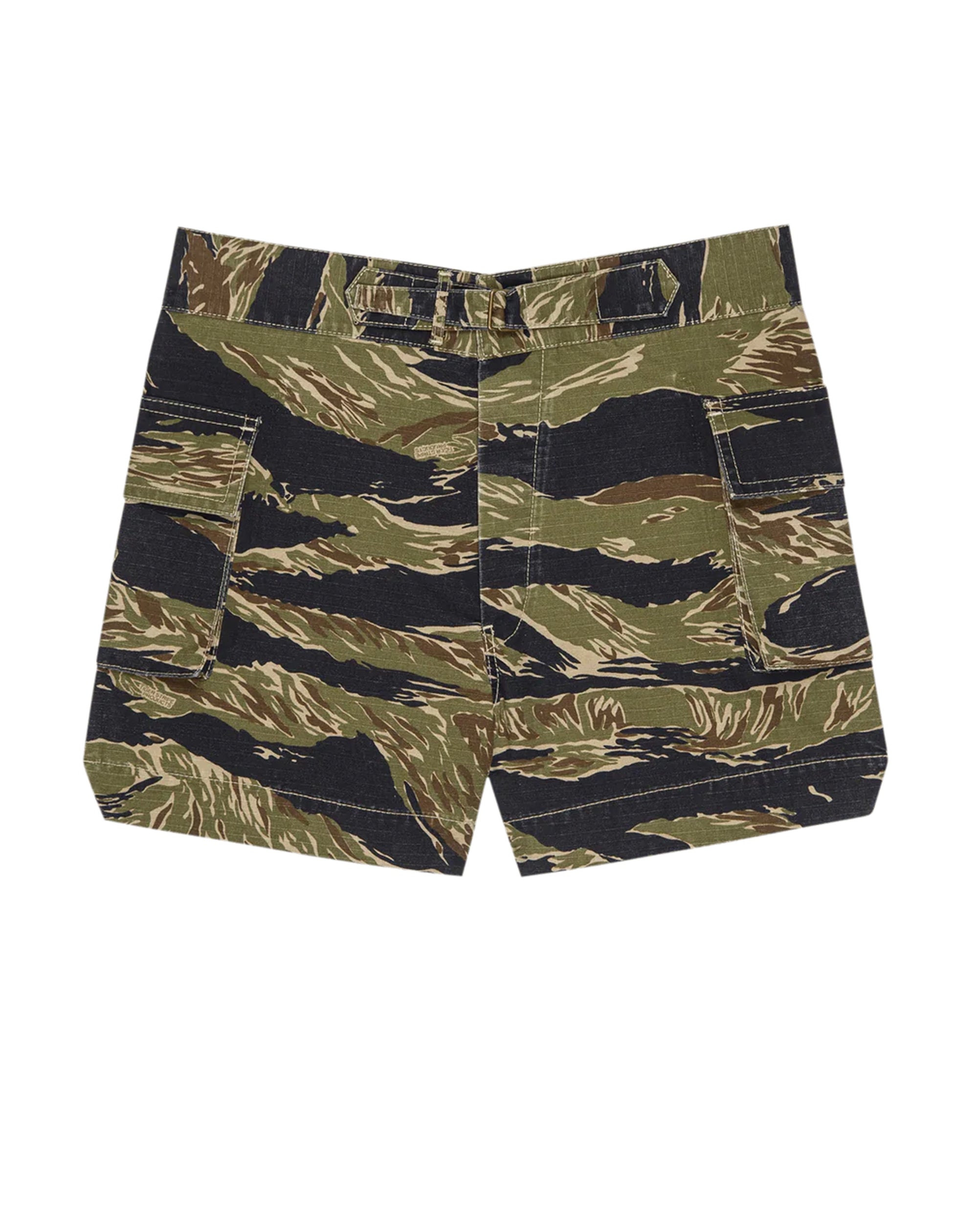 The Cargo Fatigue Short by The Great Inc. features large 3D cargo pockets and a waistband, showcasing green, brown, and black tiger stripe camouflage inspired by Vietnam War era military heritage.