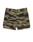 The Cargo Fatigue Short by The Great Inc. features large 3D cargo pockets and a waistband, showcasing green, brown, and black tiger stripe camouflage inspired by Vietnam War era military heritage.
