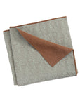 The Caroline Quilt Queen by Amity Home is a reversible cotton quilt with a light grey patterned side, solid brown underside, subtle stitched designs, and a block-print motif.