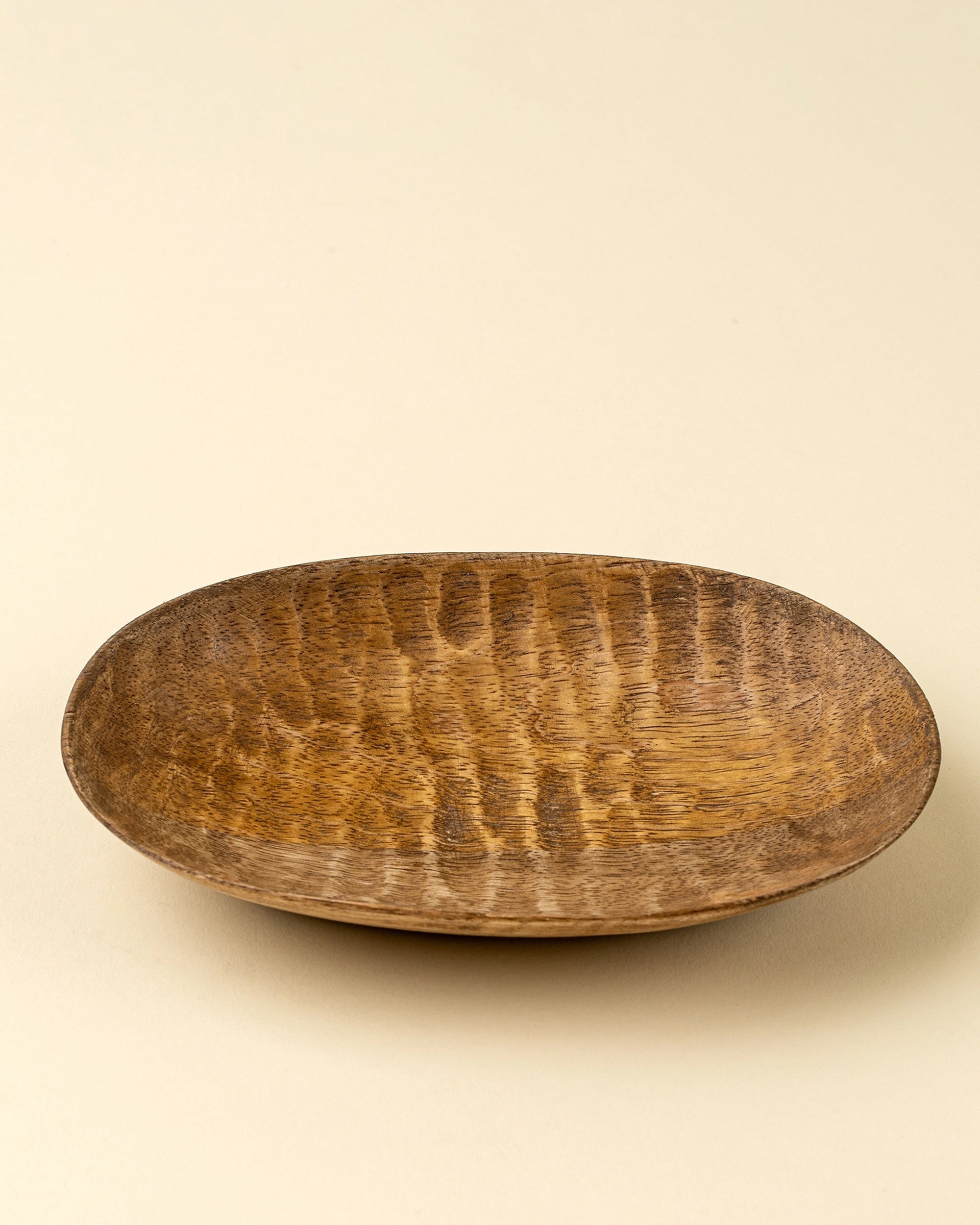 Round mango wood dish by Faire, Terrain Carved Dish S, ideal for eco-friendly decor or as a small serving plate.