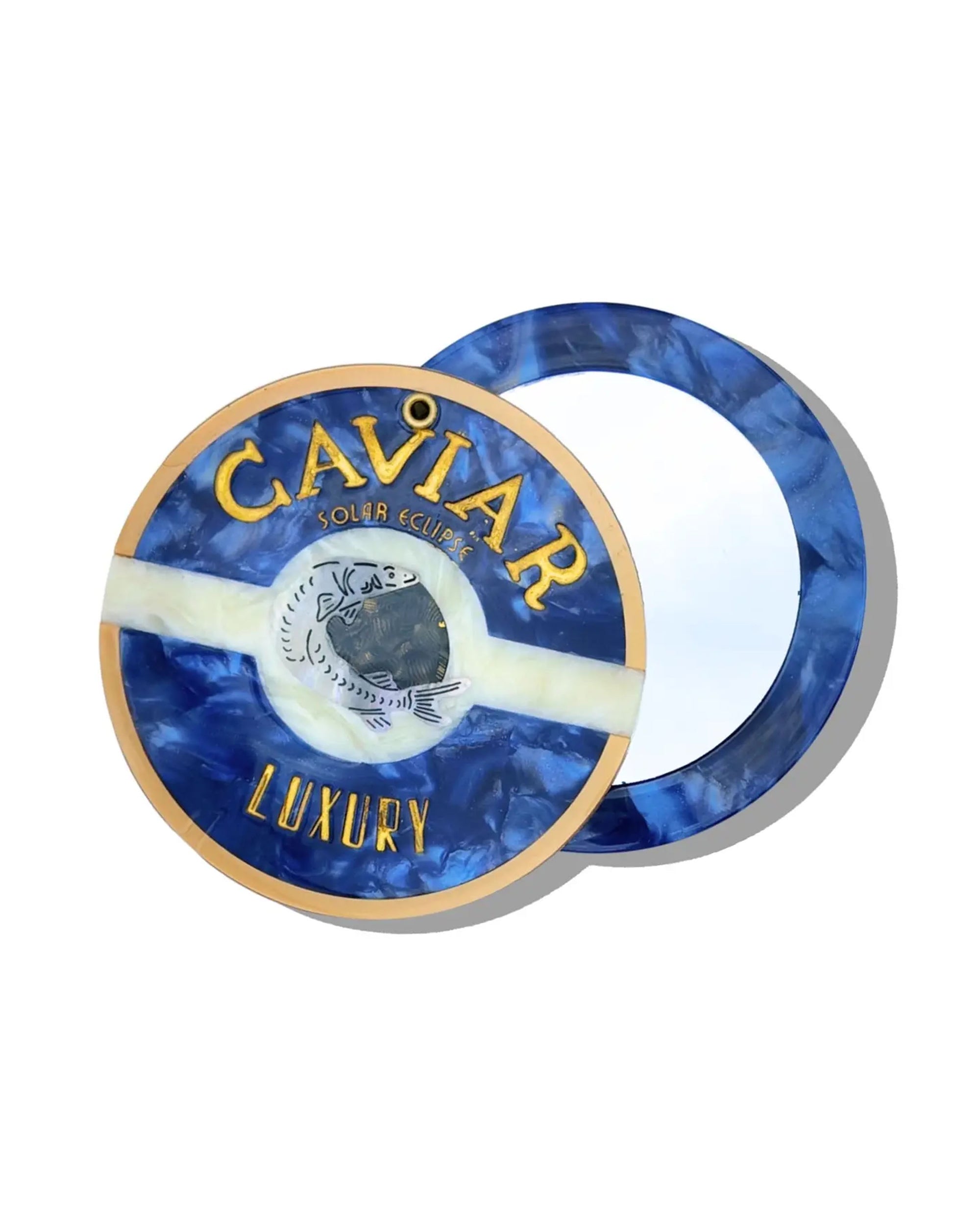 The Faire Caviar Compact Mirror features a blue and gold round design with a stylized fish logo and "CAVIAR LUXURY" label. Shown open to display the mirror, its partially covered lid makes it a must-have handbag essential.