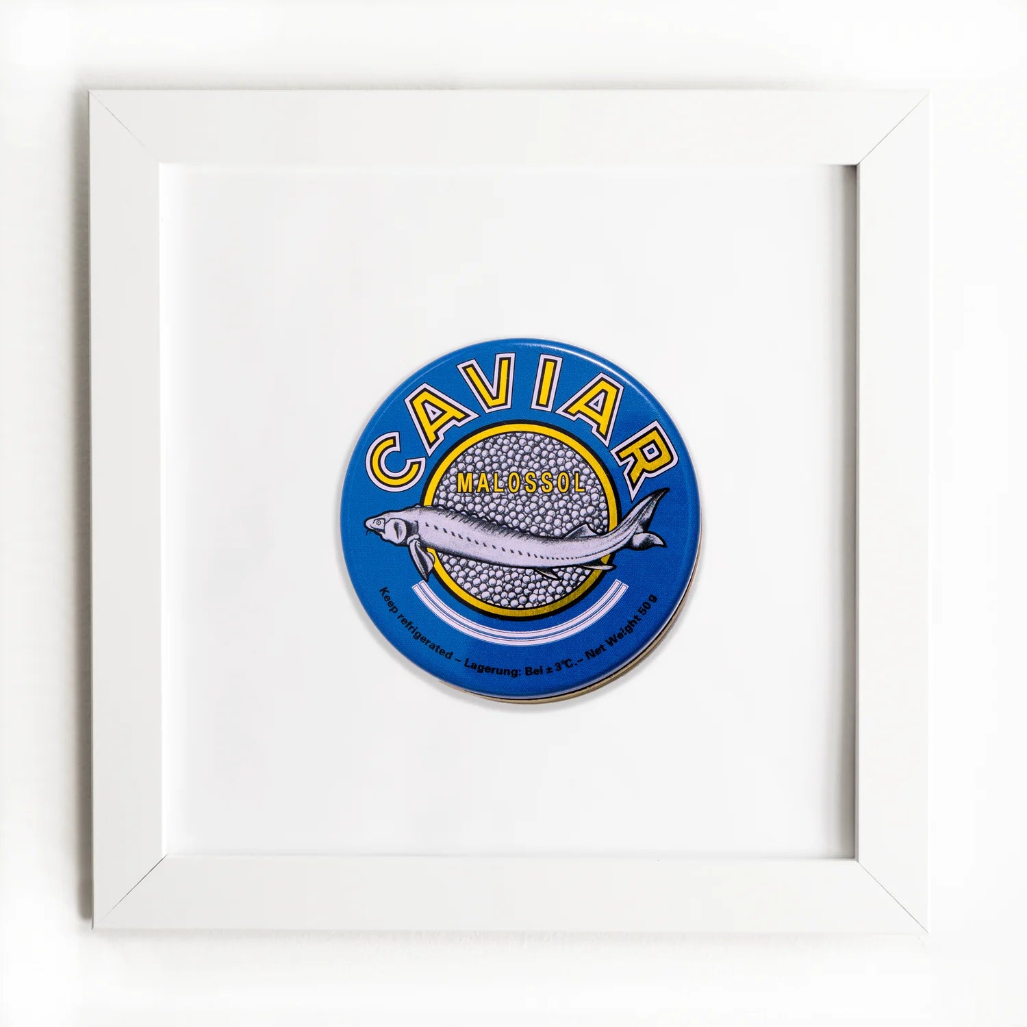 A framed graphic of a caviar tin label, featuring a blue and yellow design with an illustration of a sturgeon and the text &quot;Caviar Malossol&quot; on it, displayed against a white Match South Art Square White Frame background.