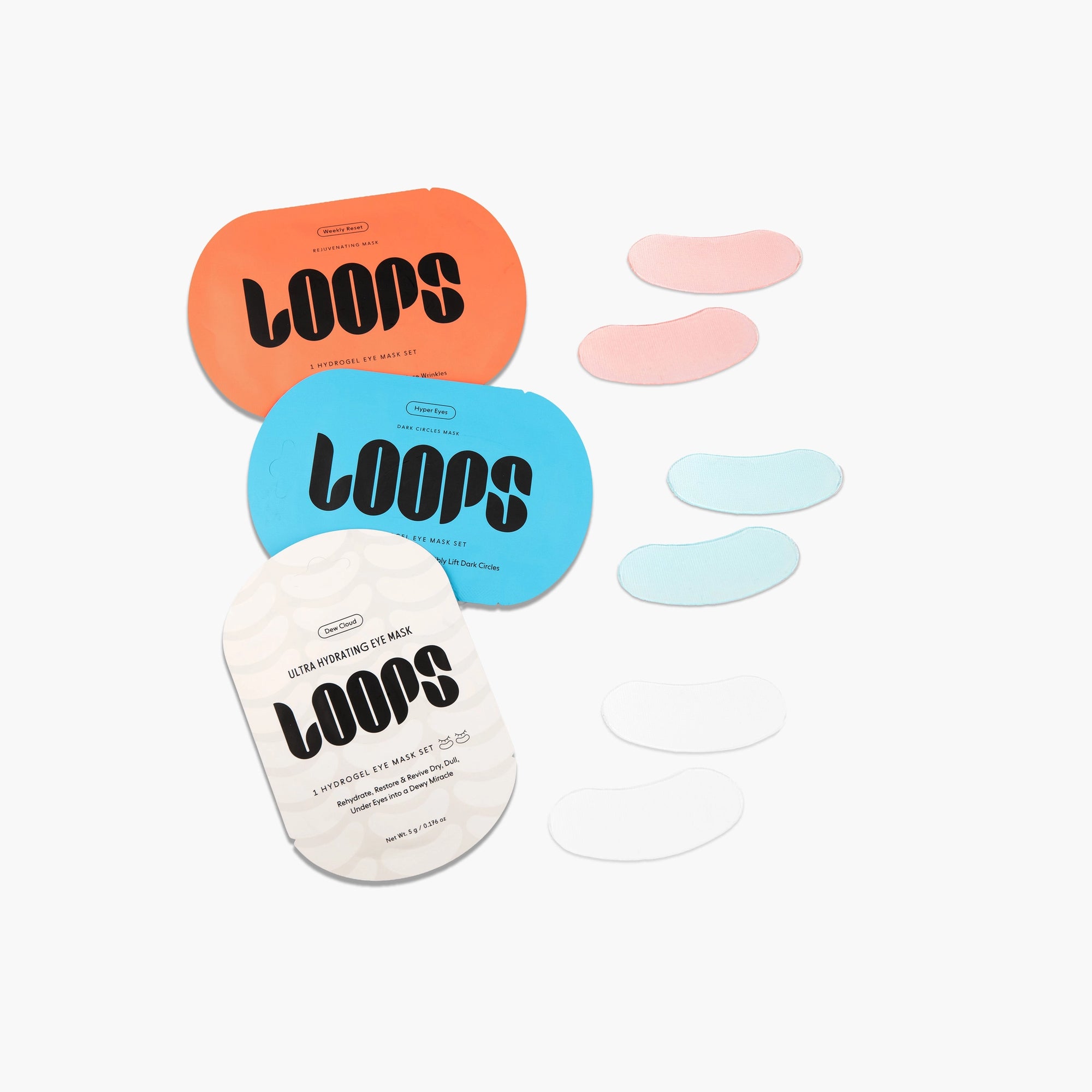 Three vibrant LOOPS HydroGel Eye Masks by Faire—orange, blue, and white packs with matching hydrogel patches in pink, blue, and white—target dark circles, all beautifully arranged on a white background.