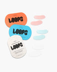 Three vibrant LOOPS HydroGel Eye Masks by Faire—orange, blue, and white packs with matching hydrogel patches in pink, blue, and white—target dark circles, all beautifully arranged on a white background.