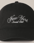 The Faire "New York Social Club" baseball cap features an embroidered text in white, a curved brim, six panels, an adjustable strap for a perfect fit, and a button on top.