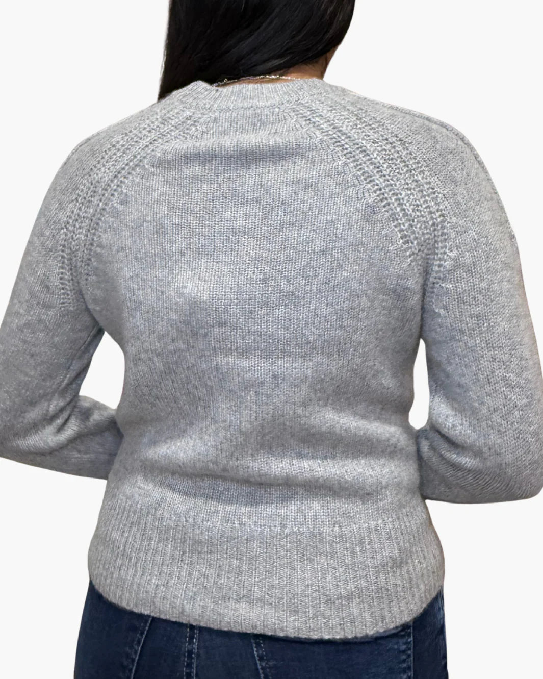 A person is shown from the back against a white background, wearing White + Warren's Cashmere Luxe Henley in light grey with dark blue jeans.