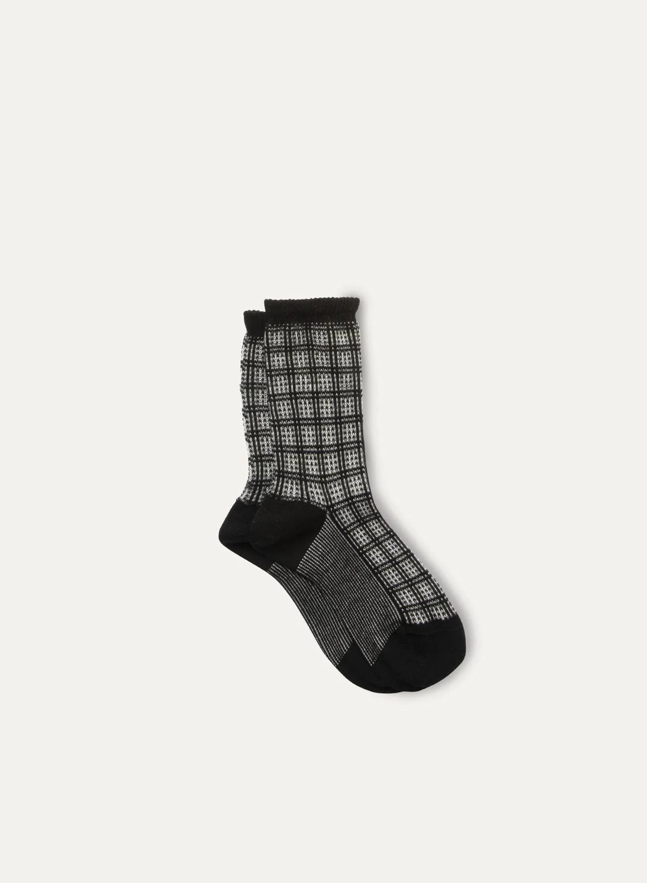 The Iceland Socks by Maria La Rosa are women's black and white checkered mid-calf socks with black toes, heels, and cuffs, made in Italy and shown on a plain light background.