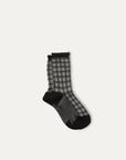 The Iceland Socks by Maria La Rosa are women's black and white checkered mid-calf socks with black toes, heels, and cuffs, made in Italy and shown on a plain light background.