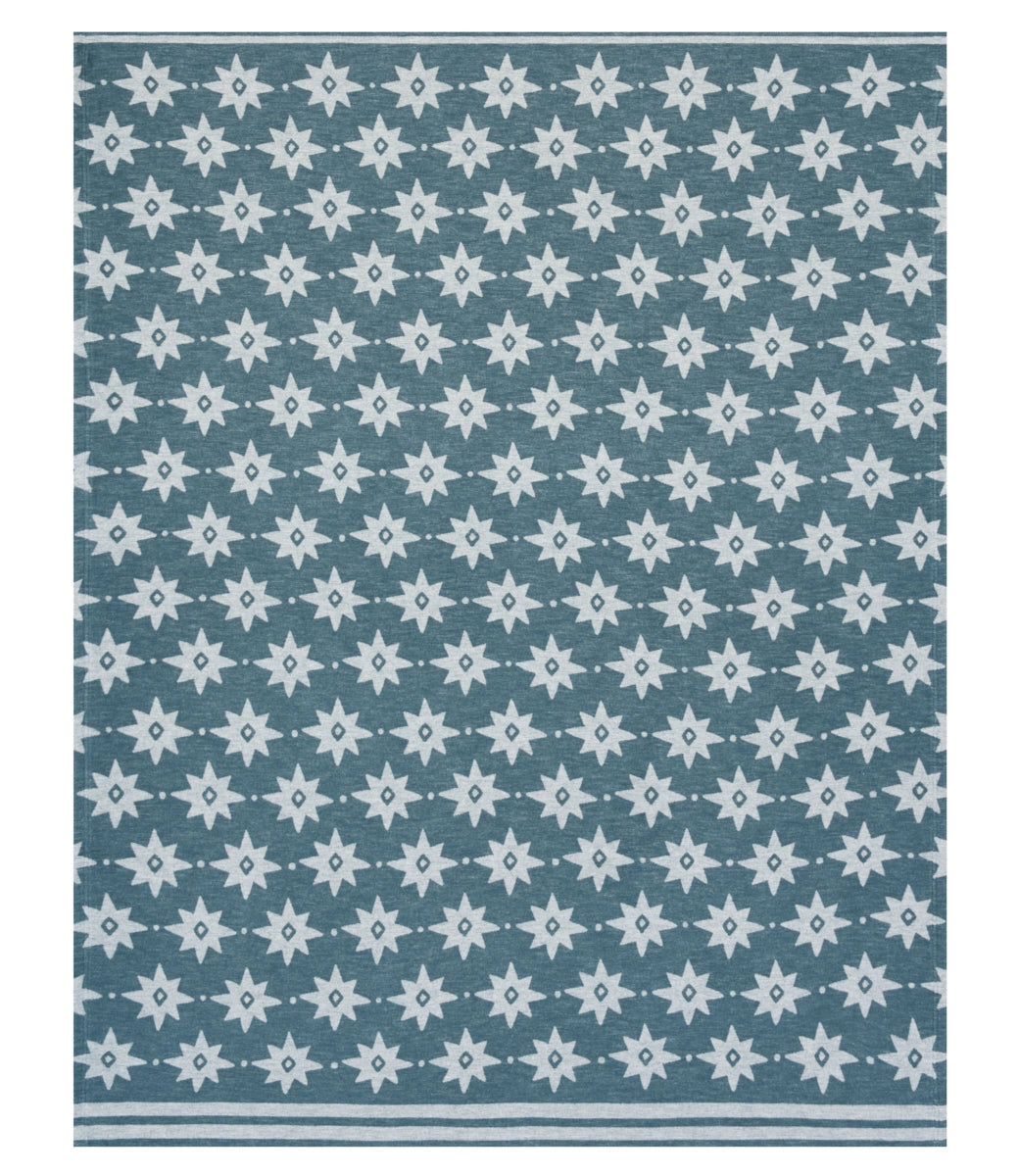 The Faire Big Sky Lightweight Blanket is a square blue throw with a repeating white eight-pointed star pattern and parallel white lines on two edges, blending striking design with the comfort of a lightweight blanket.