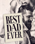 A bearded man carries a smiling girl on his shoulders, with a black and white photo showing the Faire Best Dad Ever Glass Tray 5"x8"—handcrafted in New York, signed by Ben, and featuring "BEST DAD EVER" in bold black letters.