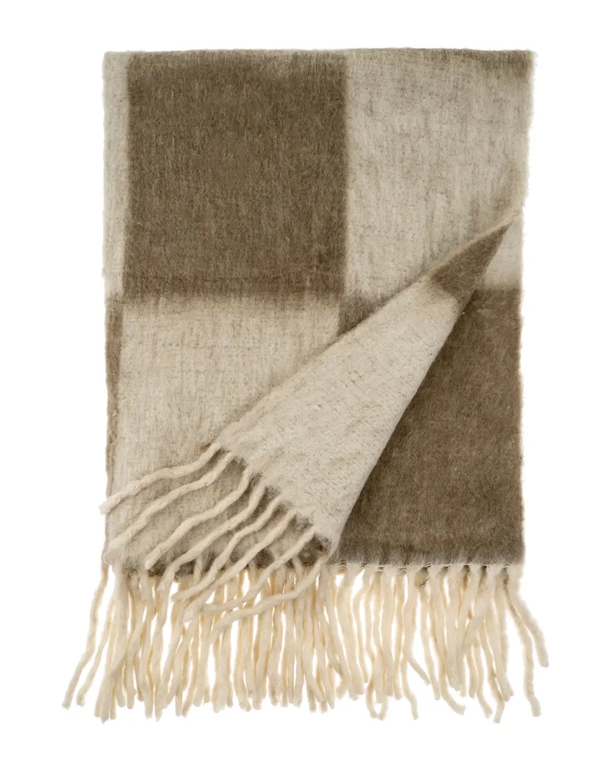 The Indaba Checkerboard Throw in Taupe features large beige and brown checkered squares with cream fringe edges. One corner is flipped over, revealing the stylish reverse side of this modern throw blanket.