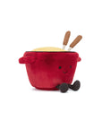 Jelly Cat Inc.’s Amuseables Cheese Fondue is a plush toy featuring a red pot with a smiling face, brown utensils in a yellow top, and soft arms and legs—crafted from cozy fabric for a delightful gift.