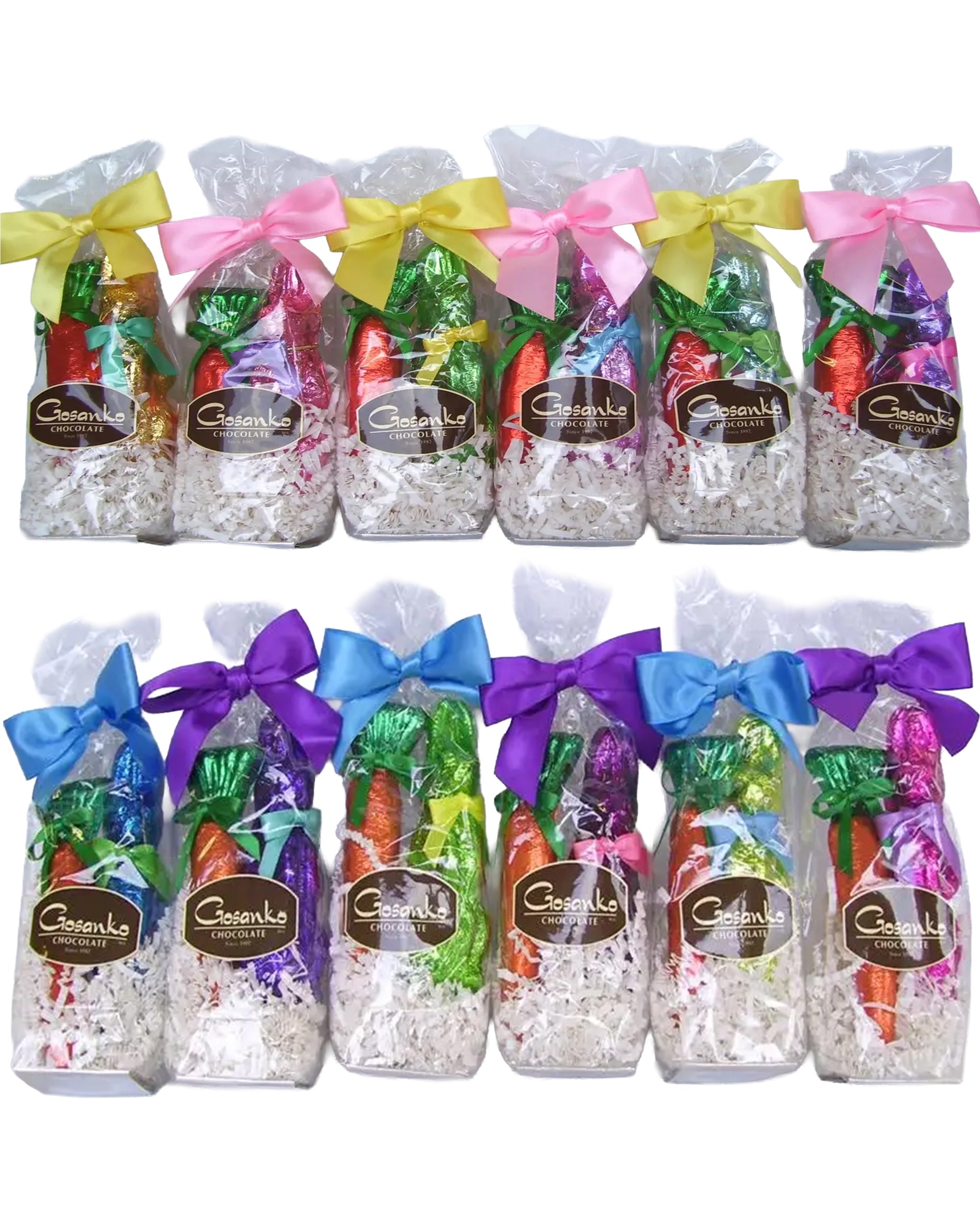 Ten EasterChoc Gift Pack bags by Faire, filled with shredded white paper and colorful foil-wrapped chocolates, each tied with a unique colored bow and labeled "Gesanke," are arranged in two rows.