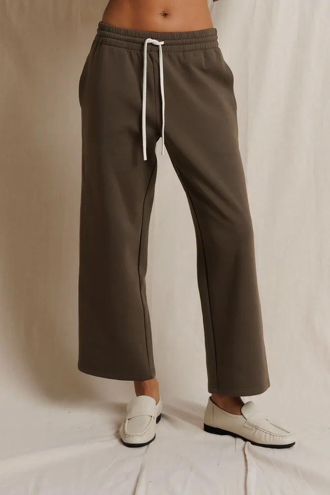 Brown stripe track pant with white drawstring by Perfectwhitetee, styled with loafers on a white background.