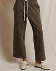 Brown stripe track pant with white drawstring by Perfectwhitetee, styled with loafers on a white background.