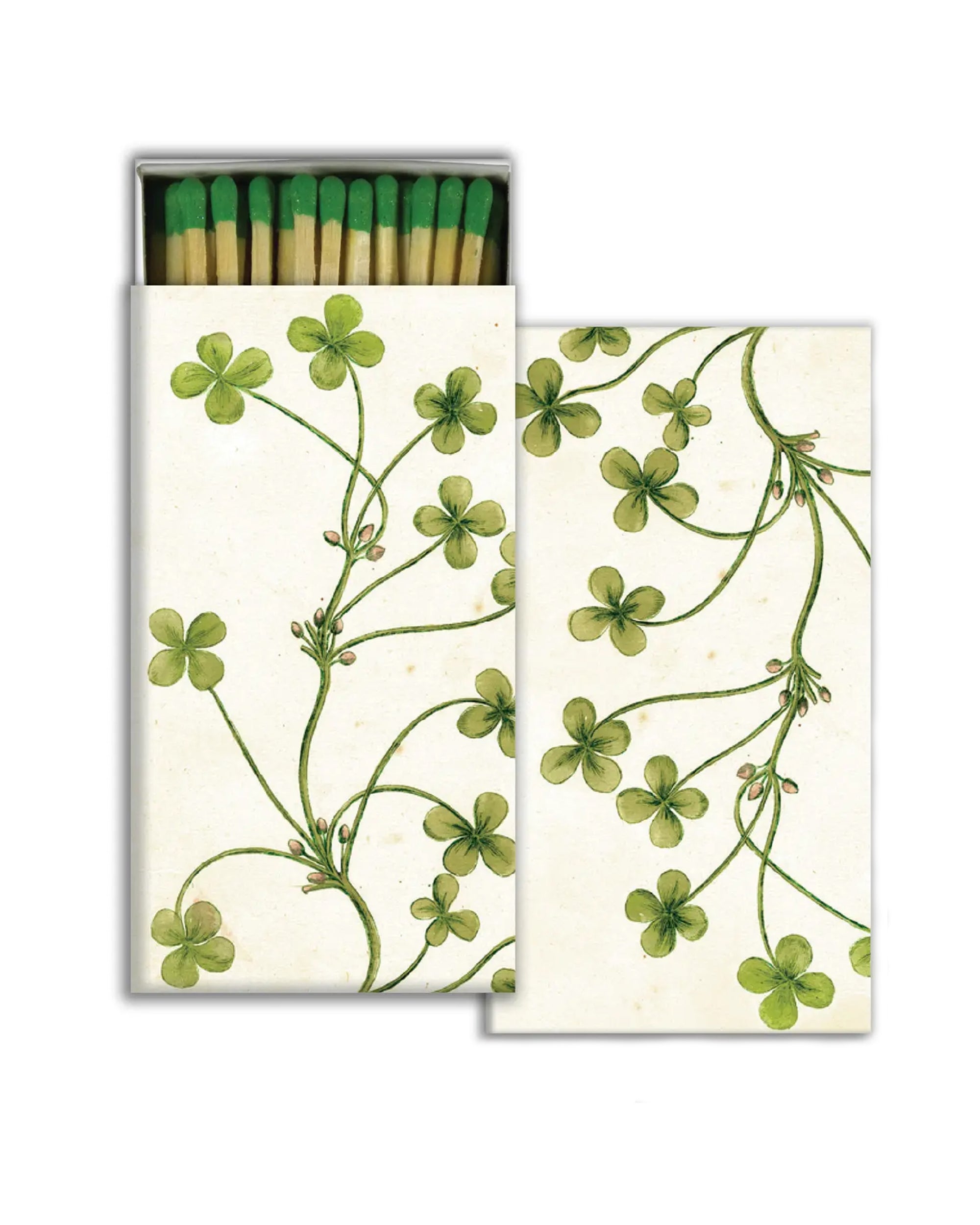 HomArt Clover Matches feature green-tipped matches in a box adorned with green clover and vine illustrations on white. The partially open box reveals the matches inside—perfect as a thoughtful hostess gift.