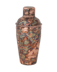 The Creative Co-op Stainless Steel Cocktail Shaker is a 16 oz shaker with a mottled, multicolored oxidized copper finish in bronze, green, and blue shades, topped with a rounded cap.