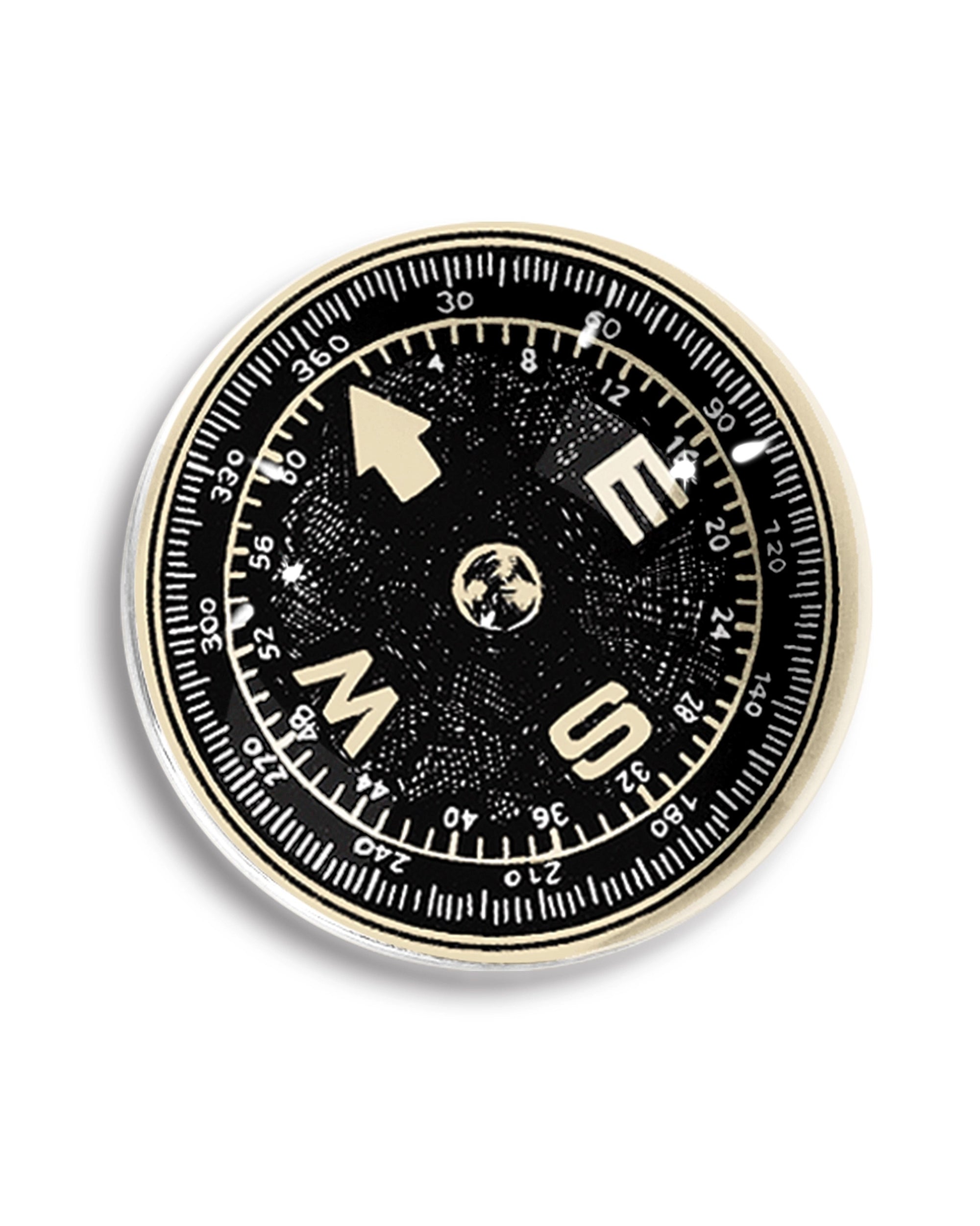 The Ben's Garden Dome Crystal Paperweight features a black and white compass with bold cardinal letters and an Earth illustration at the center, set on a white background—ideal as a unique handcrafted desk accessory.