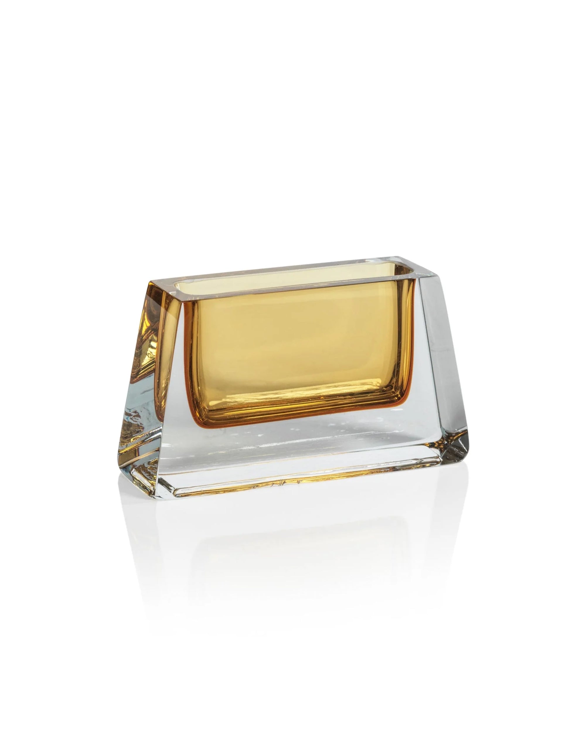 The CH-6809 Corinthia Vase short by Zodax is a rectangular amber vase with angled sides, ideal for enhancing your décor. Its golden-yellow tint shines beautifully on a white reflective surface.