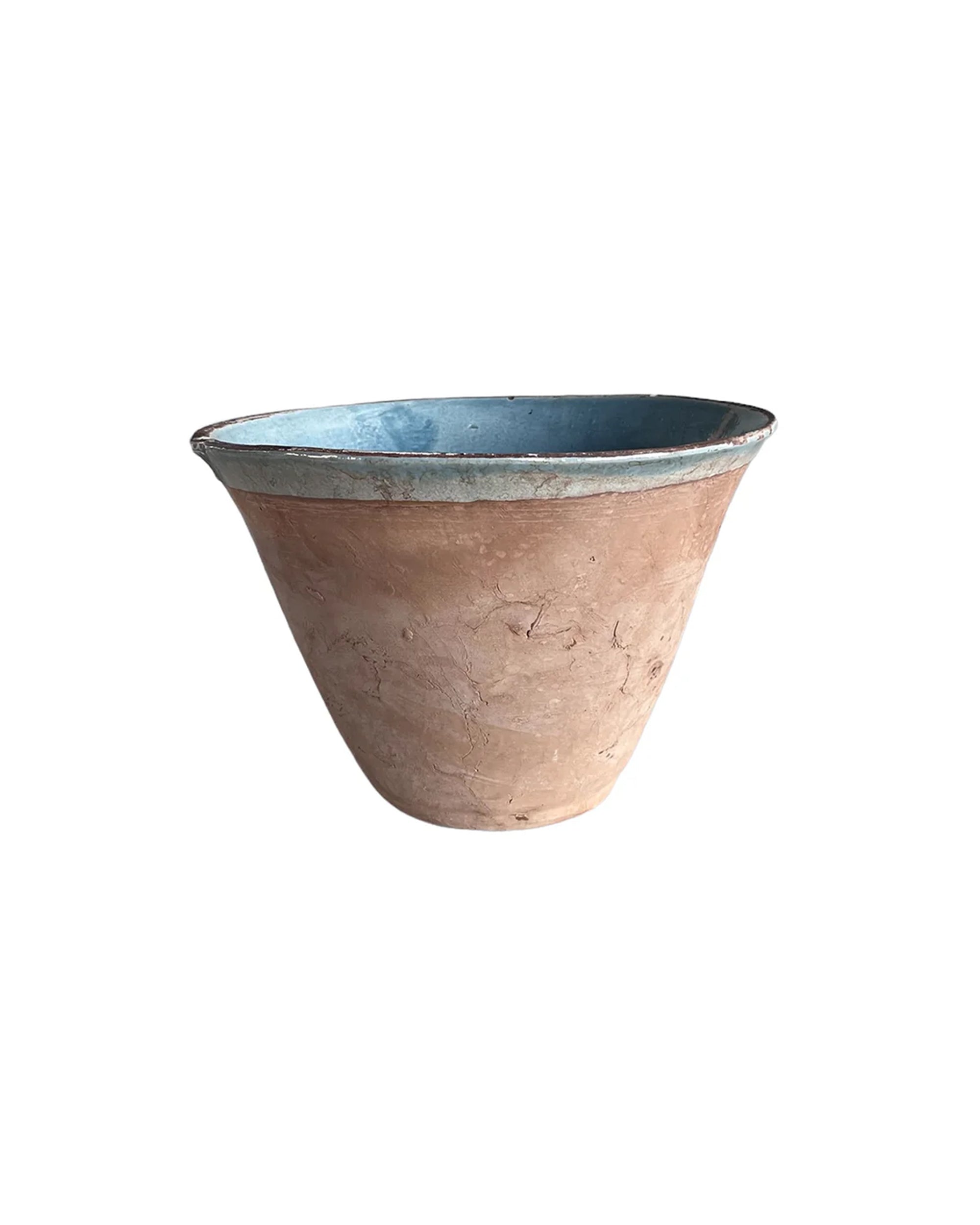 The Cottage V-Bowl by Blue Ocean Traders is a wide, round terracotta clay pot with a weathered texture and light blue interior, showcased against a plain white background.