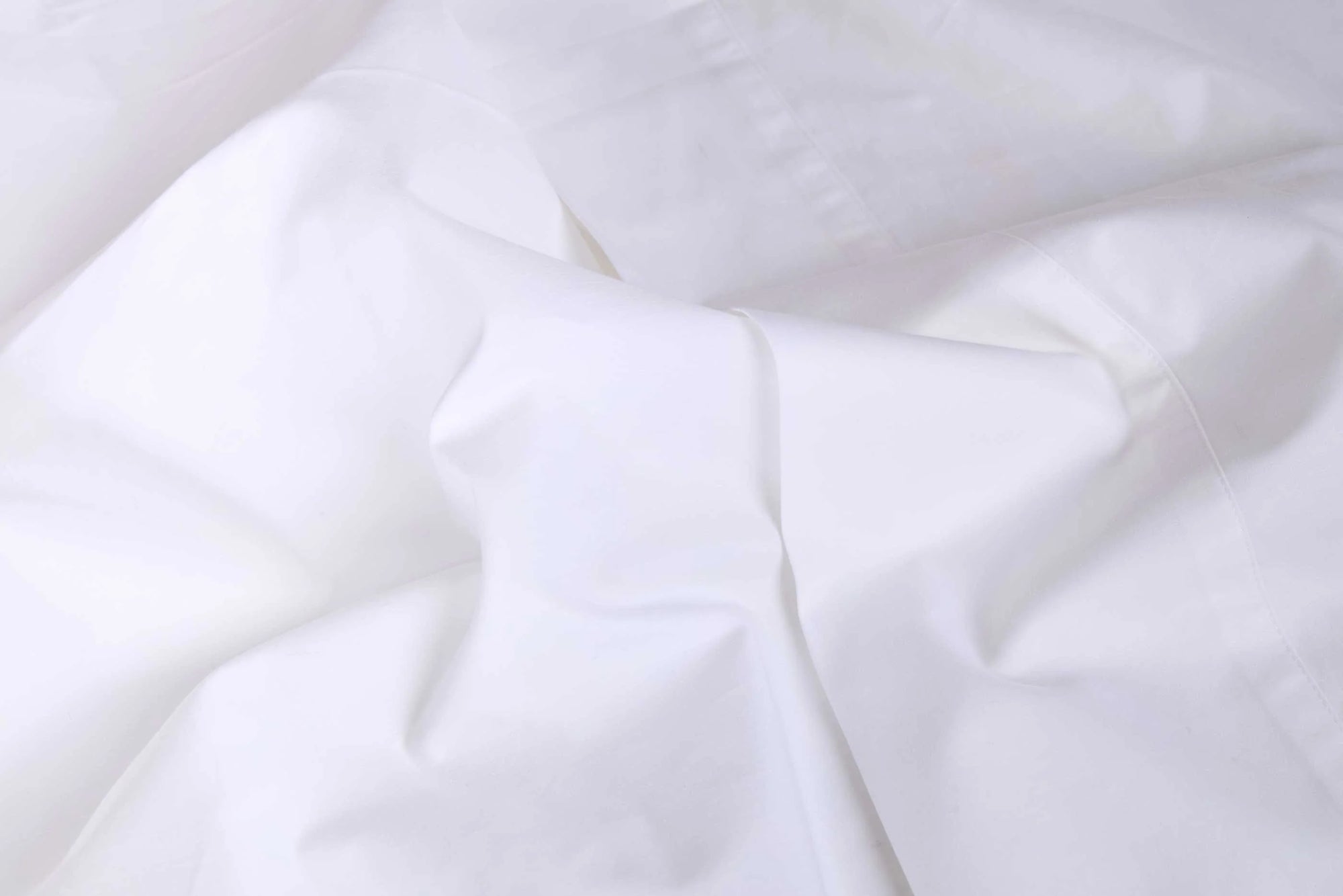 Twin cotton sateen sheet set with soft folds, smooth finish, and pom pom trim by Bungalow Furniture &amp; Accessories.