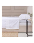 POM POM Cotton Sateen Queen sheet set in soft white, 300 thread count, styled in a cozy bedroom by Bungalow Furniture.