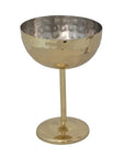 The Creative Co-op Stainless Steel Coupe Glass features a gold, hammered finish, a wide shallow bowl, and a slender stem, displayed against a white background.