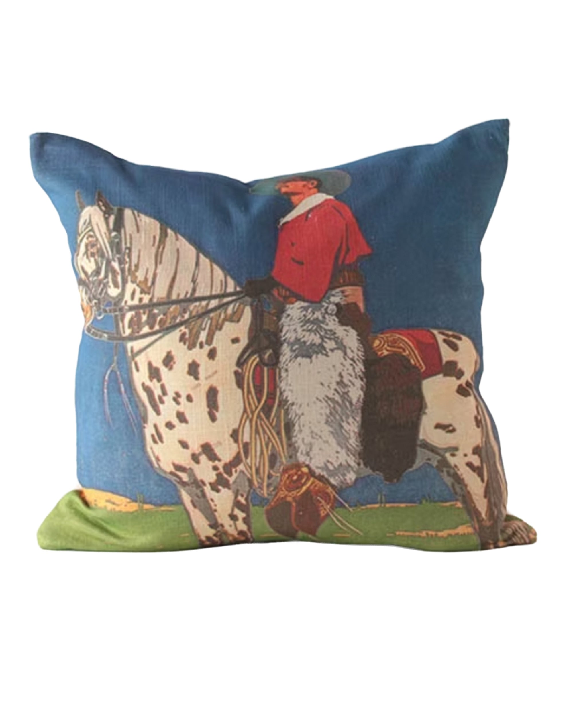 The Design Legacy SW Nat Cowboy On Spotted Horse pillow features a cowboy in a red shirt and hat on a spotted horse, set against blue and green. Fits 24x24 inserts for comfort and style.