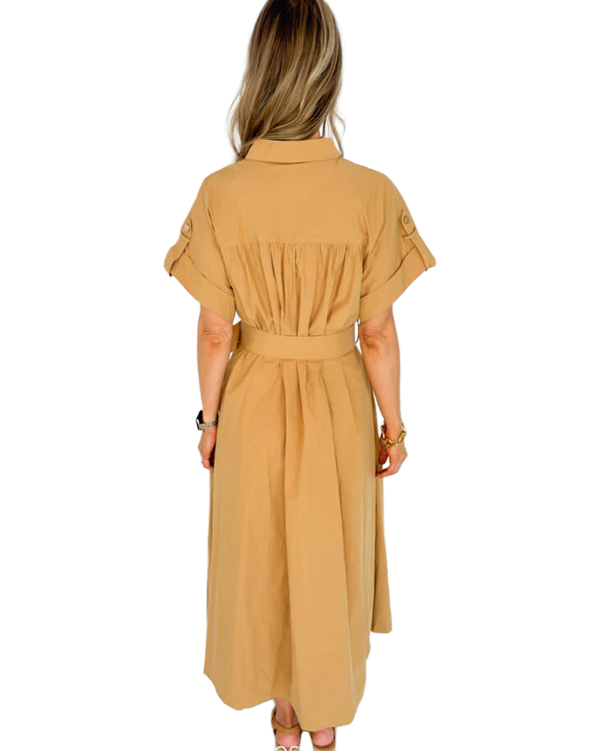 A woman with long, wavy hair is shown from the back wearing the SUNCOO Cristal Dress, a tan belted style with gathered details and rolled-up sleeves, set against a white background.