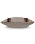 The CRISTOBAL FAUX LEATHER pillow by Eastern Accents is a grey rectangular accent with brown woven leather stripes and braided end accents, shown from the side against a white background.