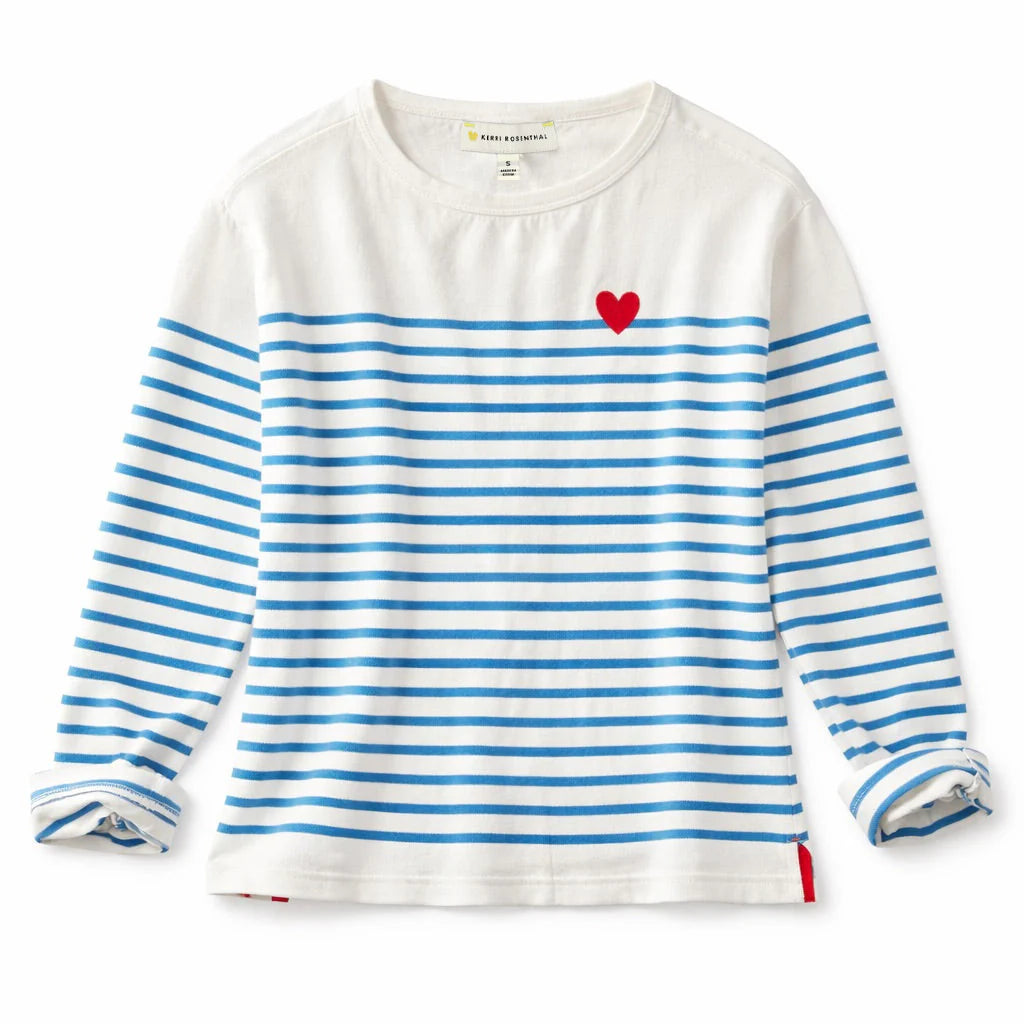 The Kerri Rosenthal Artist Long Sleeve Stripe Tee is a white shirt with horizontal blue stripes, a small embroidered heart on the upper left chest, and slightly rolled cuffs for a relaxed look.