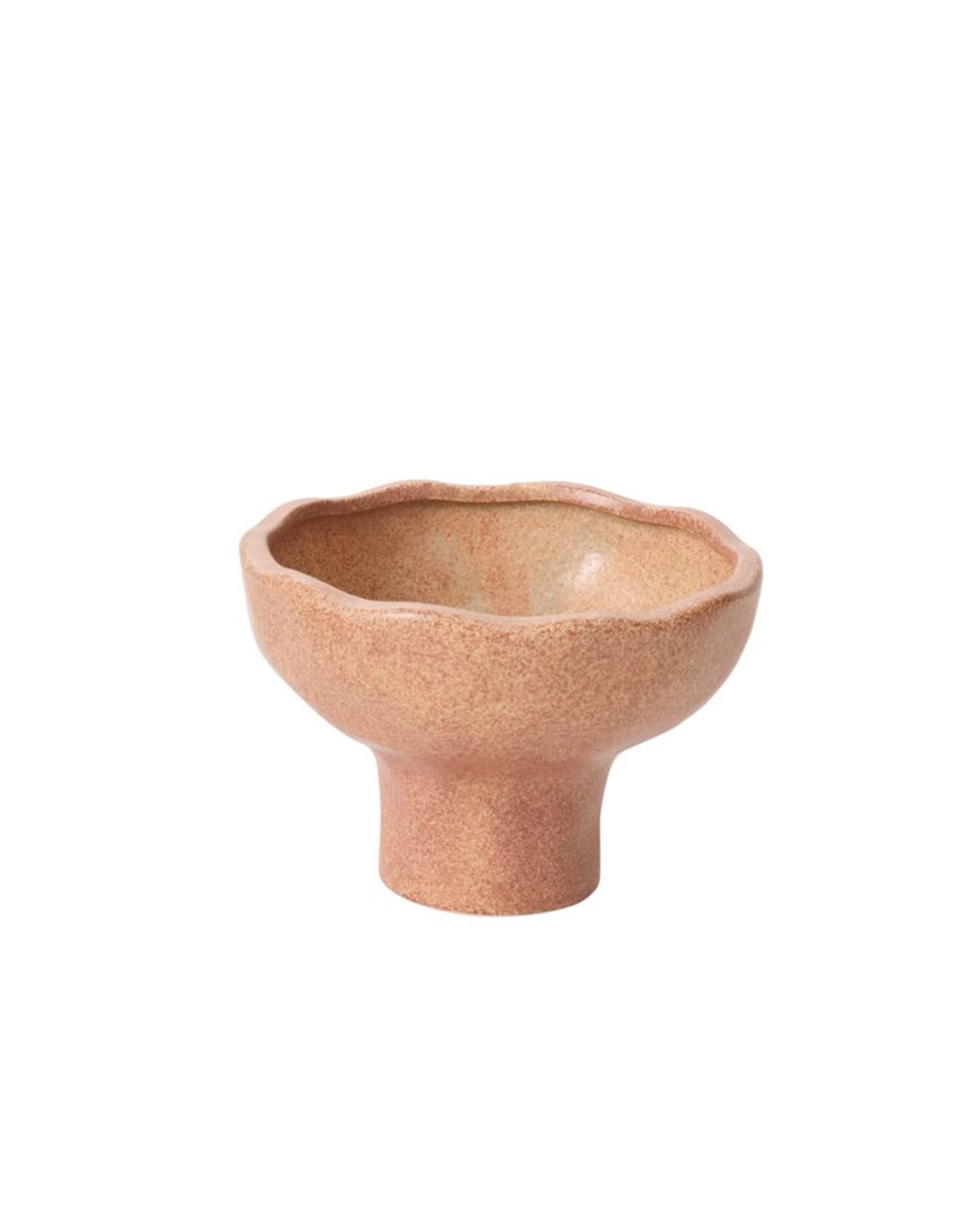 The 54846 Cyrus Compote by Accent Decor is a small ceramic piece with a wide wavy rim and short pedestal base, featuring a pinkish-beige speckled glaze, shown against a plain white background.
