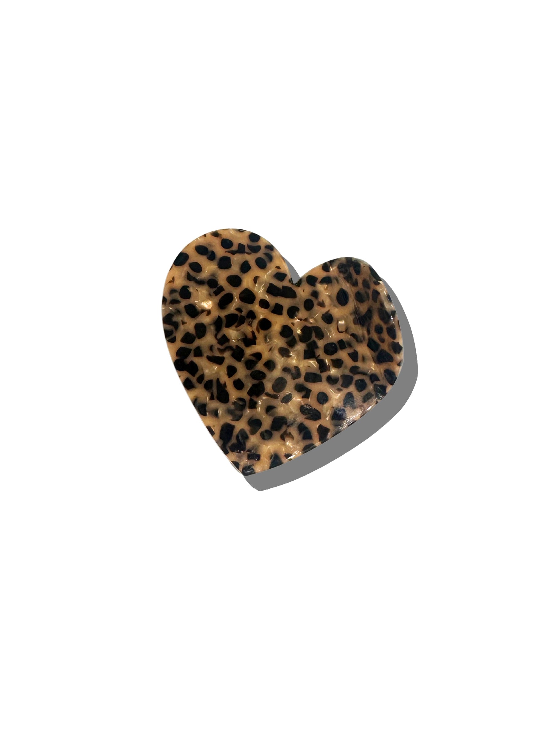 The Fashion Hair Clip by Faire features a glossy, heart-shaped design with a brown and black leopard print, crafted from eco-friendly cellulose acetate. It is shown against a plain white background with a faint shadow.