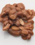 A close-up of Faire's LC Peanut Brittle 12oz on a white background, highlighting the irresistible appeal of this crunchy snack.