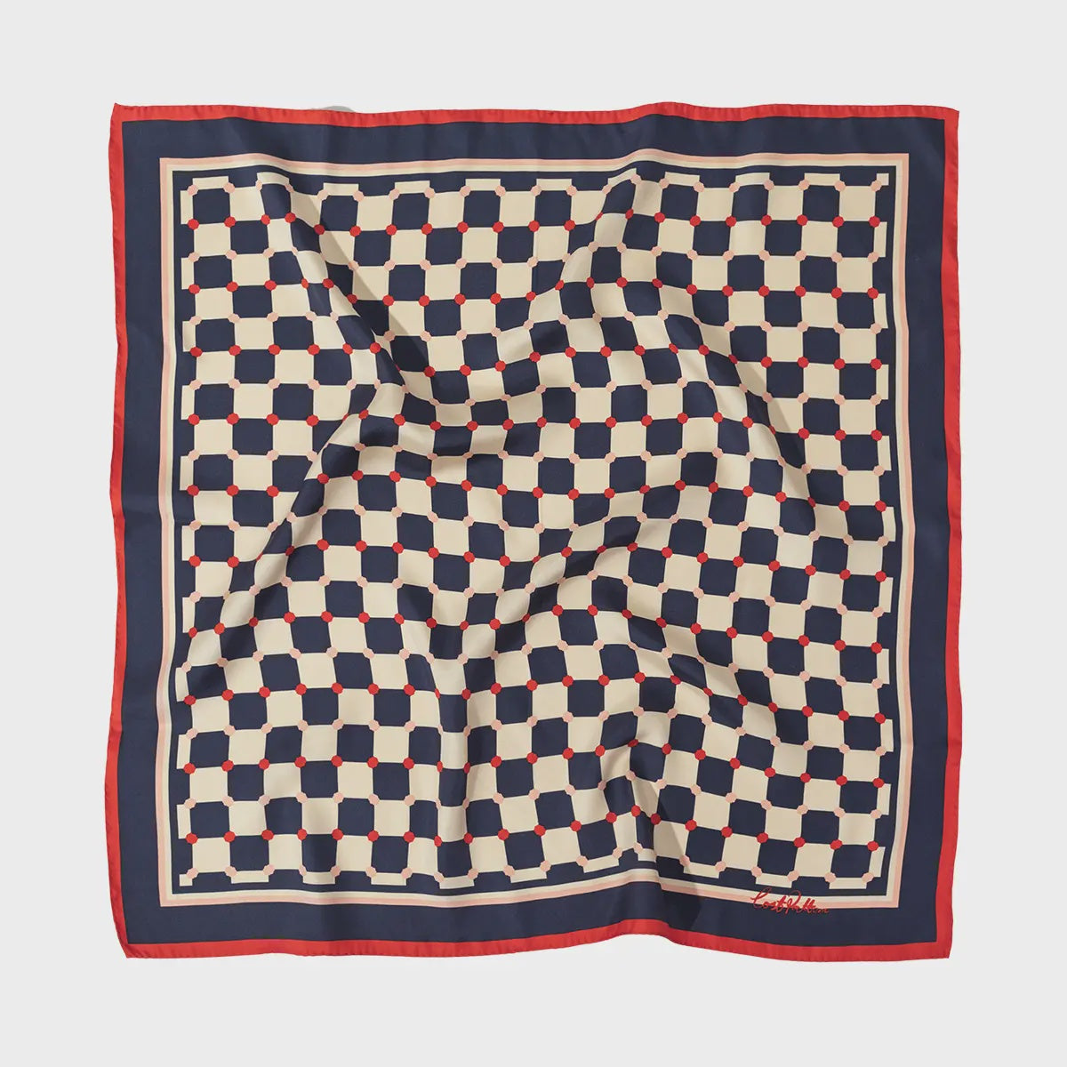 The Checkerboard Silk Bandana Americana by Faire features a geometric pattern with navy, red, and cream hues. This 100% silk twill scarf is elegantly finished with a red border and hand-rolled edges, while its slightly wrinkled texture adds a unique depth to this sophisticated accessory.