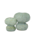 Two small, round Connolly Vases by The Import Collection feature a textured surface and glossy light green finish, placed side by side against a white backdrop—ideal handcrafted ceramic accents for modern organic decor.