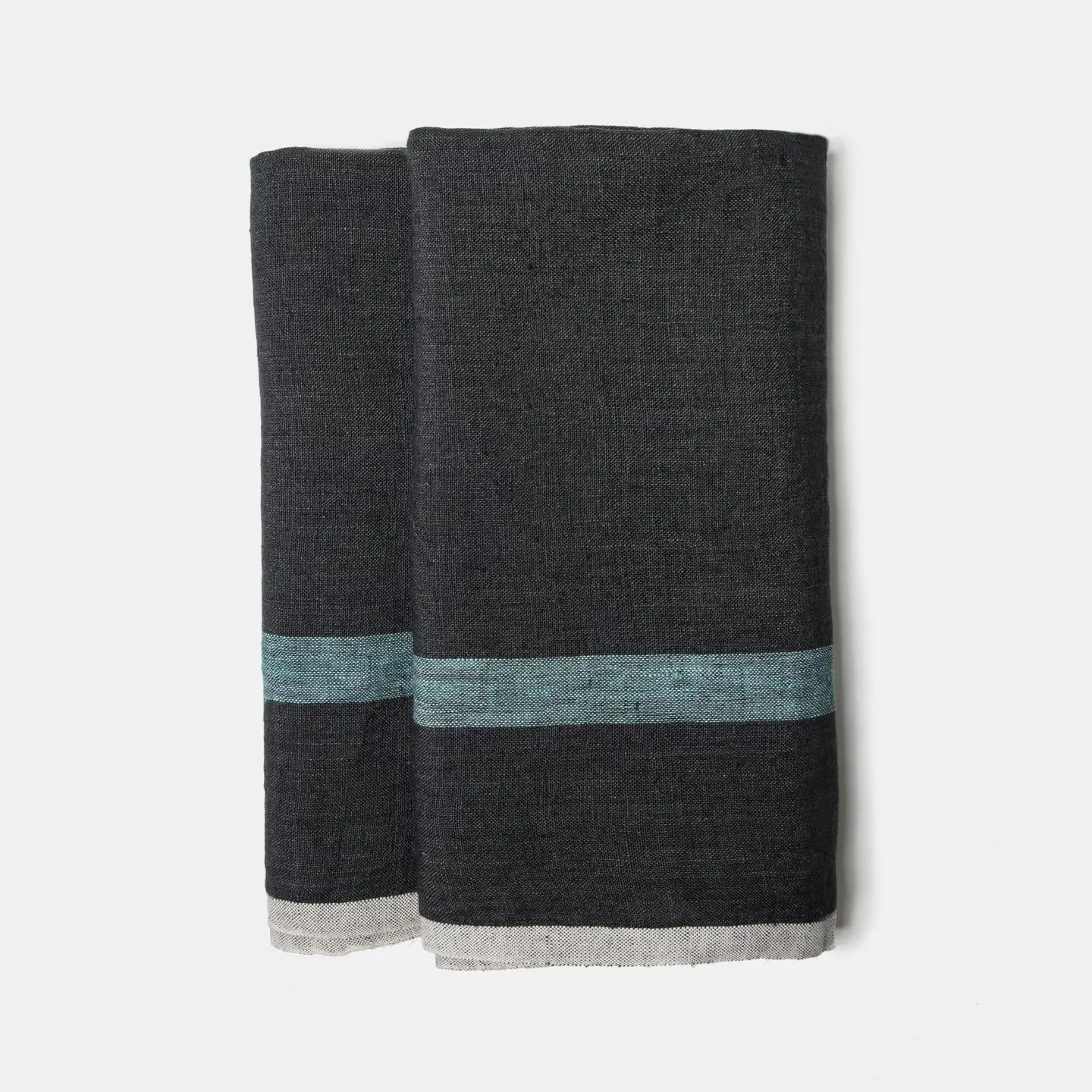 The CH Tea Towels S/2 by Faire feature dark gray linen with a horizontal teal stripe and thin light gray edge, shown folded side by side on a white background.