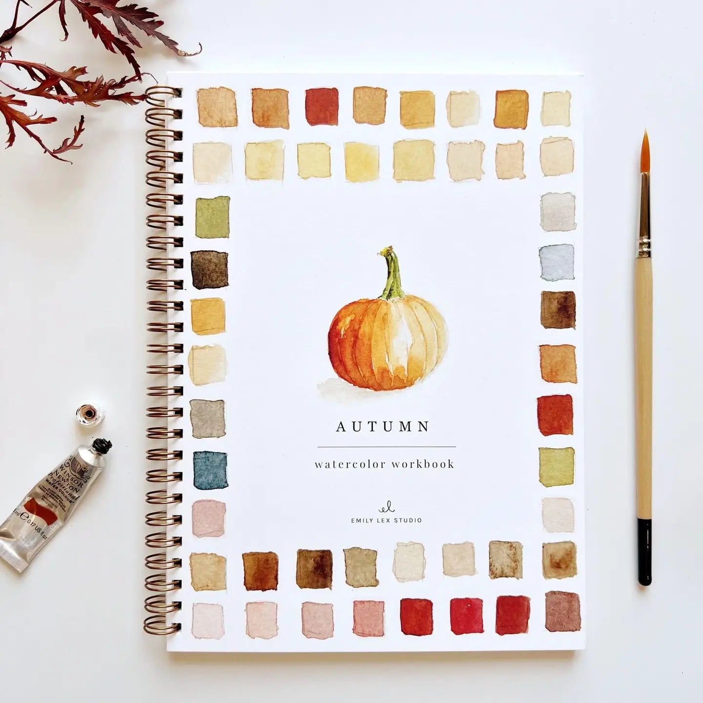Spiral-bound autumn watercolor workbook with pumpkin and leaves by Faire, beginner-friendly design.
