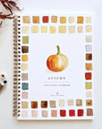 Spiral-bound autumn watercolor workbook with pumpkin and leaves by Faire, beginner-friendly design.