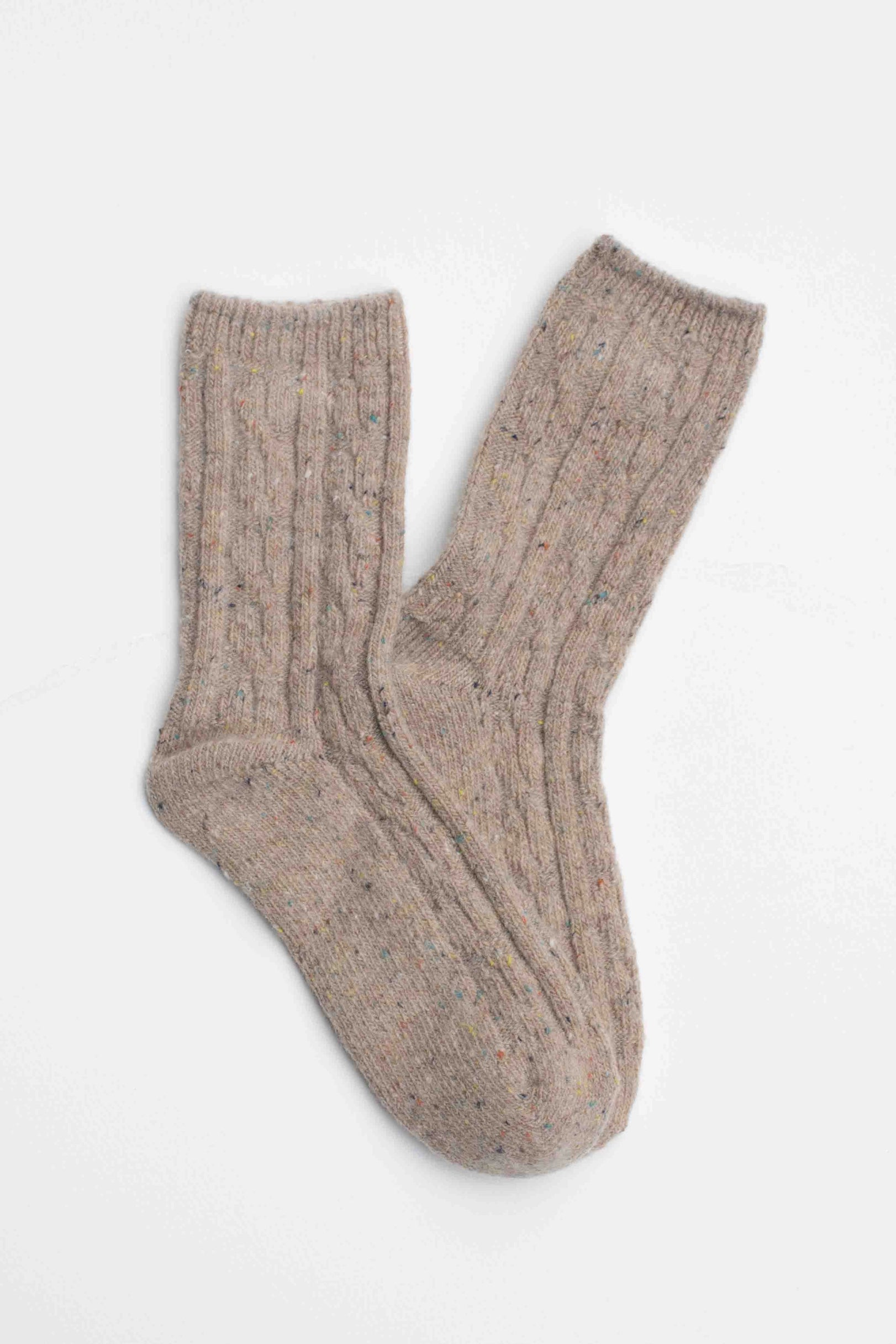 Faire Wool Speckled Knit Socks in beige feature a ribbed and cable-knit pattern, made from a wool-blend, and are shown laid flat on a white background.