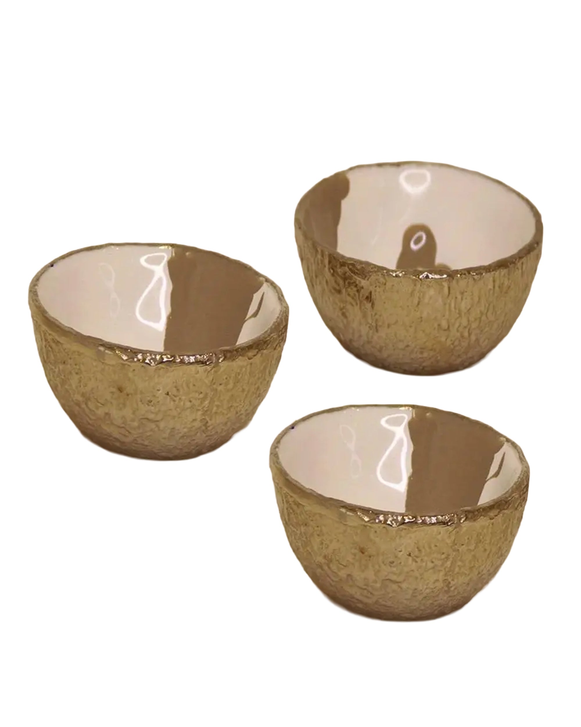 Three Dansbury Snack Bowls by Faire, featuring a textured gold exterior and smooth, glossy white interior, are arranged against a plain white background.