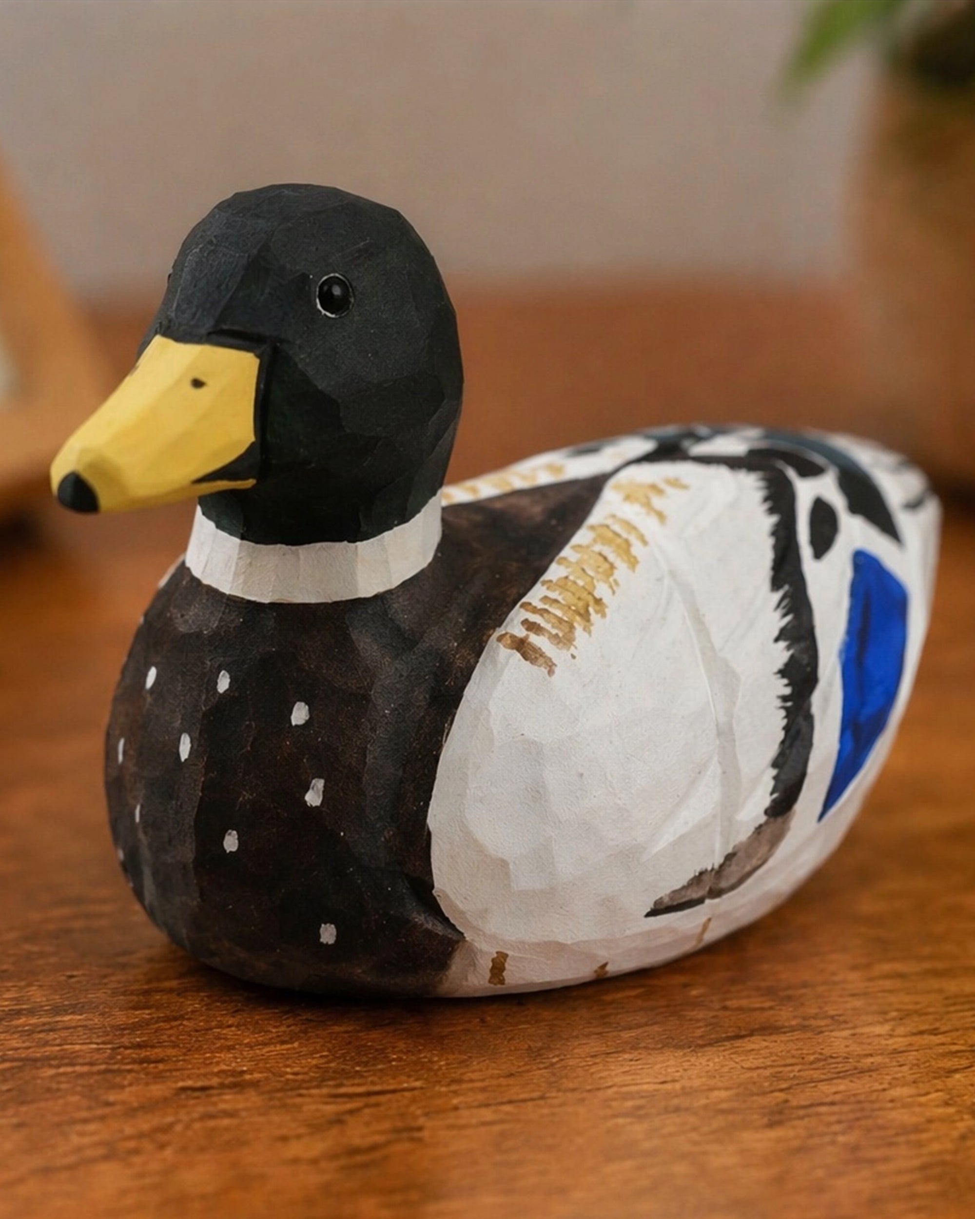 Hand-painted black basswood duck by Faire with carved details, perfect for adding rustic charm to home décor.