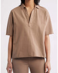 Patty Popover SS Henley by Frank & Eileen in white with tan pants, styled simply against a neutral background.