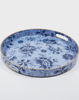 The Blue Floral Round Tray by Faire features an elegant design with its blue floral pattern and gold trim, enhanced by handles for sophisticated organization in any setting.