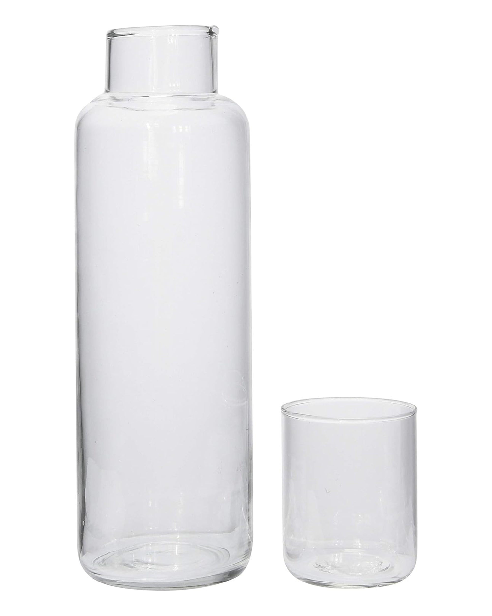 The Creative Co-op DF3660 Decanter With Glass is a stylish 32 oz clear glass set with a wide-neck carafe and a small cylindrical drinking glass, both empty and displayed against a plain white background.
