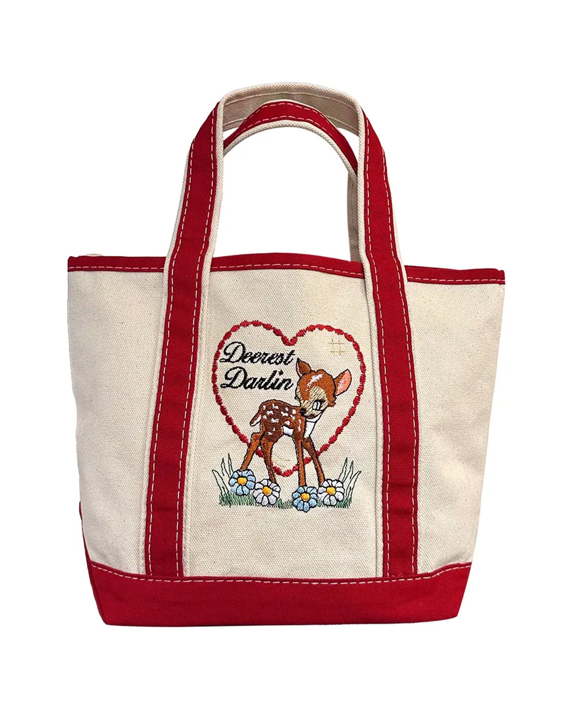 The Faire Deerest Darlin' tote features a cream color with red handles and trim, fawn artwork, and "Dearest Darlin" inside a heart surrounded by flowers.