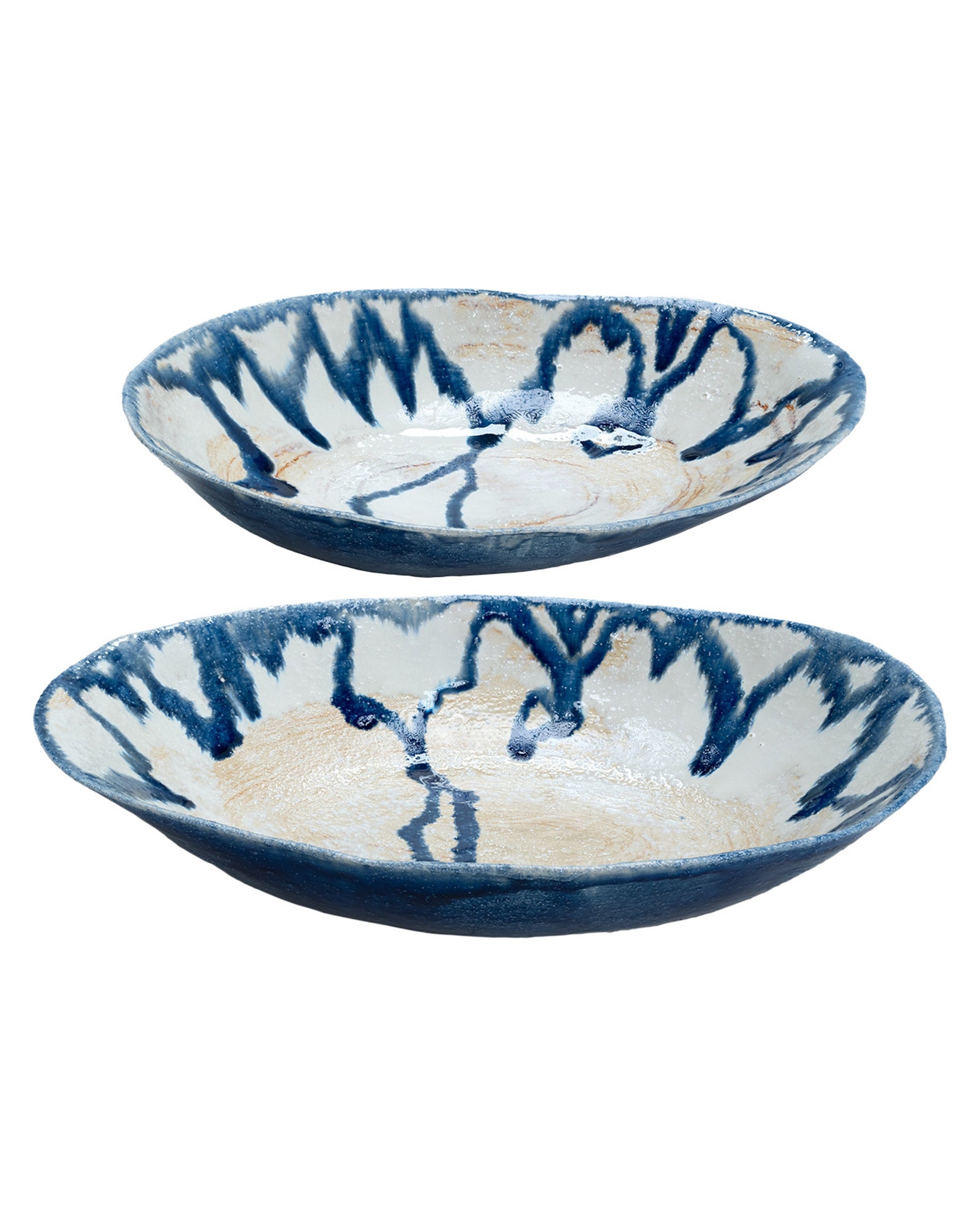 The Import Collection’s Demario Bowls are shallow stoneware pieces with irregular rims, a cream base, and abstract blue streaks. Their handmade look makes these blue and white bowls perfect as artistic decor for any room.