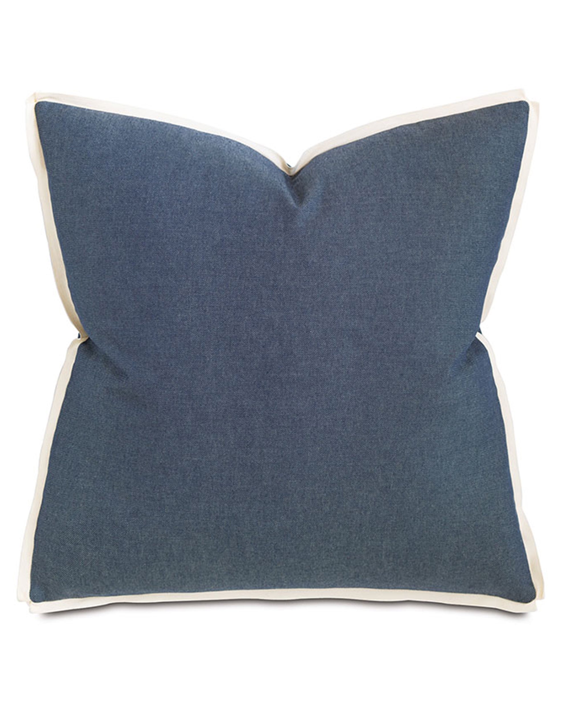 The Strauss Denim pillow by Eastern Accents features a square blue design with subtle texture, white border, and classic ribbon flange. Includes pillow insert. Shown on a plain white background.