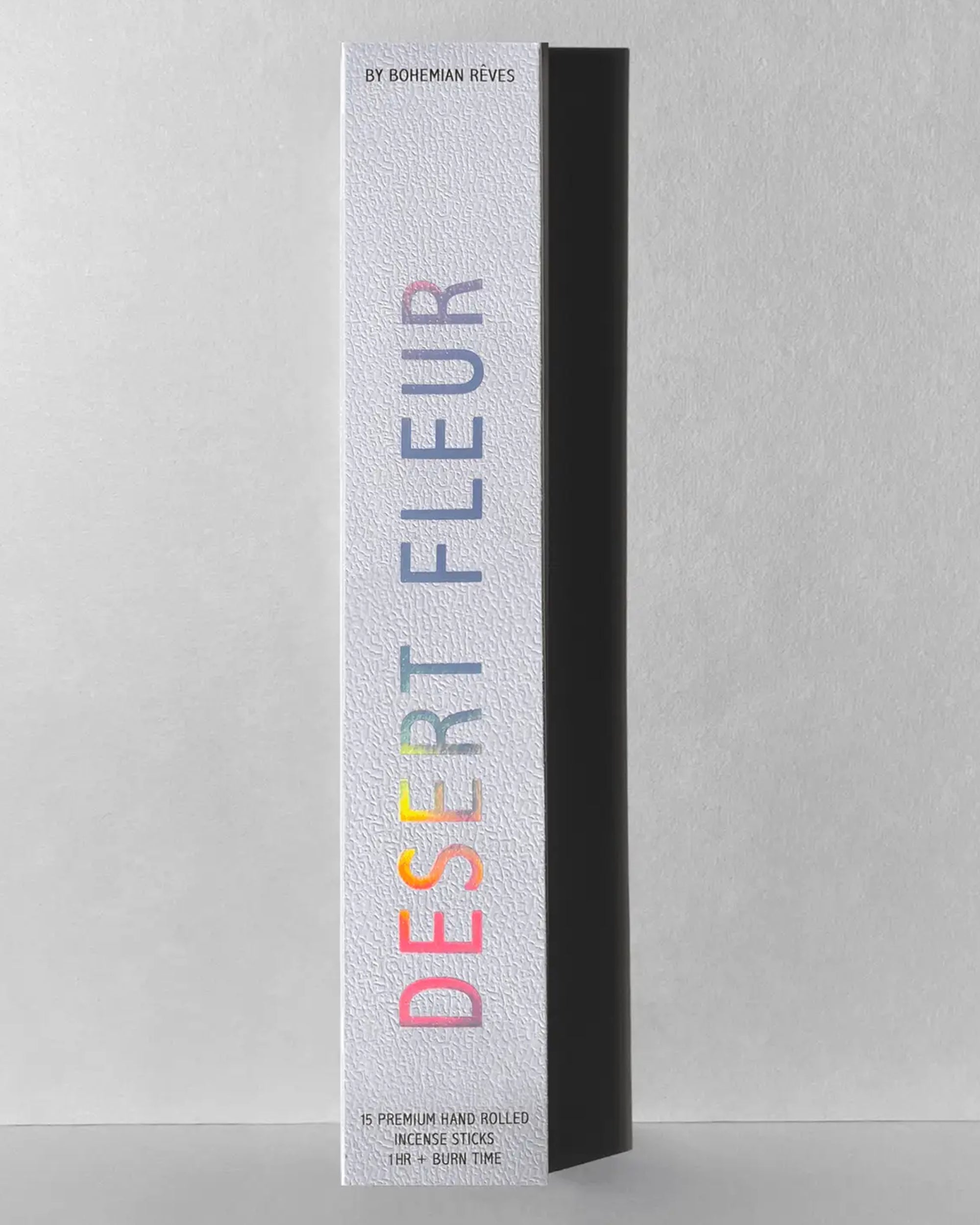 A white textured box displays "Desert Fleur Incense Sticks | Earthy & Iconic" by Faire, with 15 premium hand-rolled sticks (1+ hr burn). Enjoy a botanical incense experience featuring an earthy patchouli vanilla aroma.